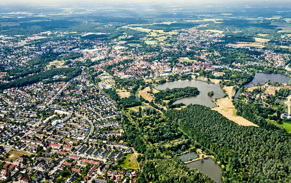 Aerial view of gifhorn cityscape and residential areas nestled between forests and lakes in lower saxony, germany