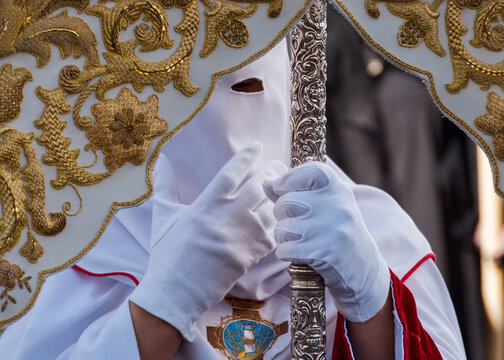 Traditional Penitent in White Capirote Holding Carved Silver Staff