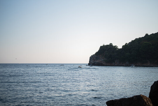 Scenic view of the calm blue sea and a forested rocky coastline in Budva, Montenegro
