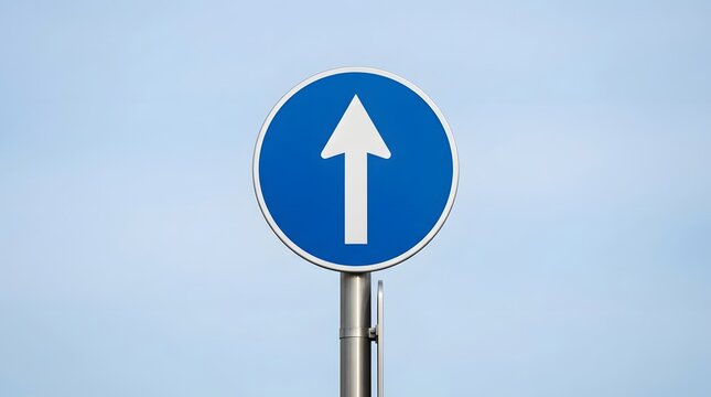 Blue traffic sign with a white upward arrow, against a clear blue sky background