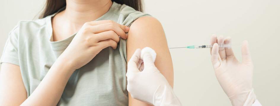 Health care, corona virus, hand of woman nurse, doctor giving syringe vaccine, injection dose on arm sick patient at clinic. Vaccination, immunization disease prevention against flu pandemic influenza