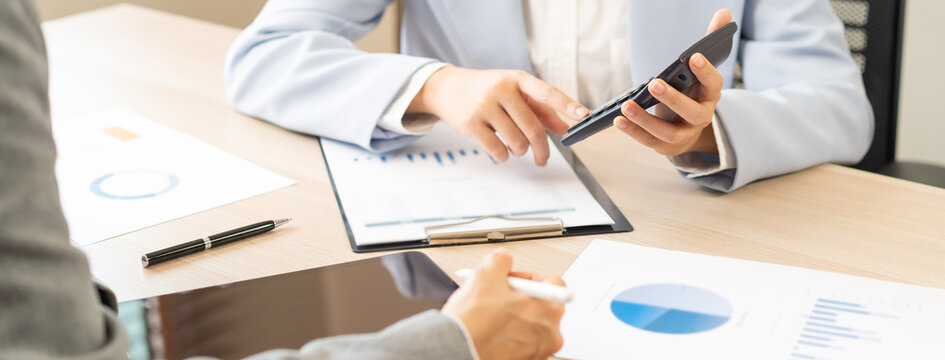 Business meeting, asian group brainstorm analysis on graph data of cost plan. financial consult planning investor asses and present to client, client and advisor review investment strategy in office.