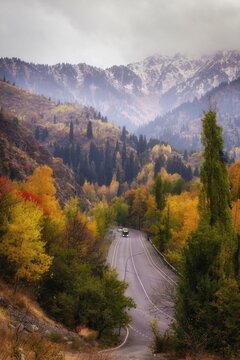 Winding road to Medeu tract surrounded by colorful autumn trees in Almaty mountains, Kazakhstan. 