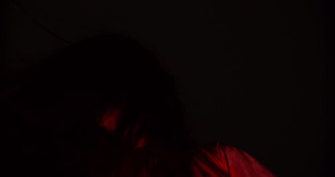 A terrifying demonic figure with one glowing eye emerges from pitch-black darkness, embodying a nightmarish and evil supernatural presence for a disturbing horror concept.