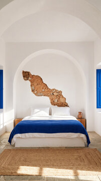 Stone vein flowing from vaulted ceiling above serene white coastal bedroom