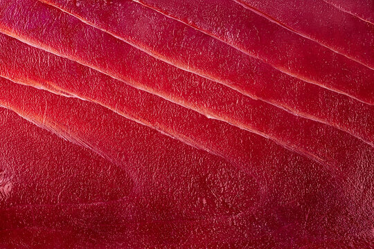 Macro texture of fresh raw red tuna fillet meat sashimi background