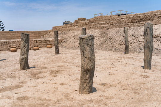 Ancient wooden roof support pillars at Huaca Pucllana archaeological site in Lima, Peru