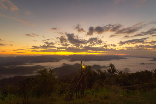 Man standing on Gloselo Viewpoint at sunrise, Sop Moei District, Mae Hong Son Province, Thailand