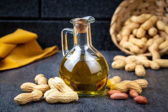 Peanut oil in glass bottle and peanuts