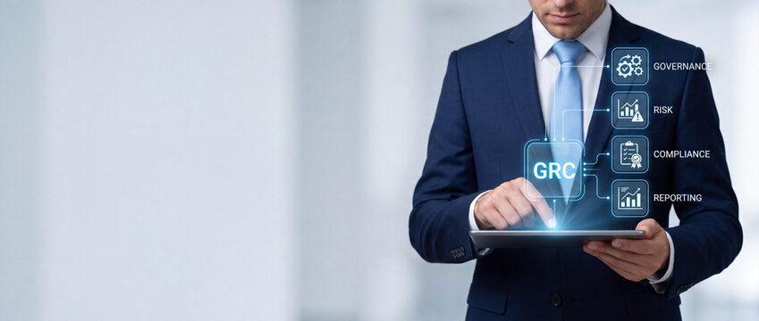 Businessman using tablet for GRC Governance Risk and Compliance strategy with virtual icons for corporate reporting and digital data security.