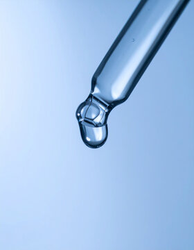 Glass laboratory dropper releasing single clear liquid droplet, clean scientific background, cool clinical lighting, medical research concept. Close-up.
