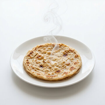 Steaming hot freshly cooked paratha flatbread on a plate