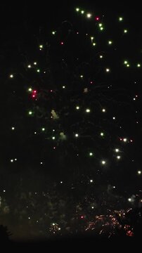 VERTICAL VIDEO: Colorful Red And Golden Fireworks Bursting During Spectacular Pyrotechnic Show At Night. Festive Celebration For New Year, Christmas, Holiday And Festival Events.