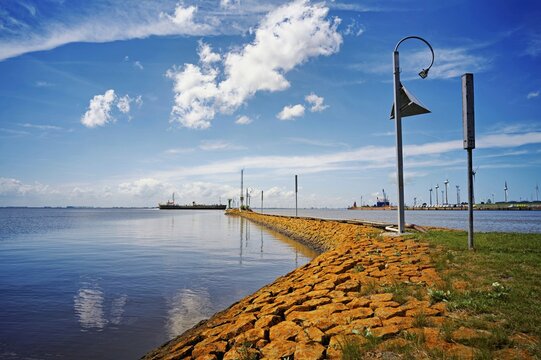 Stone breakwater leading to Emden's outer harbour, East Frisia, Lower Saxony, Germany
