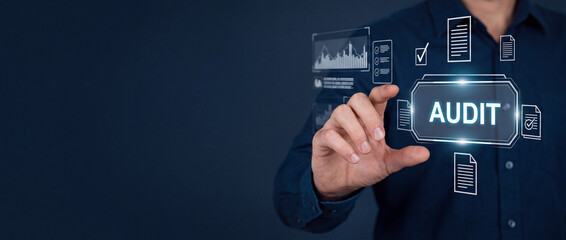 Obraz premium Businessman interacting with a futuristic digital audit interface featuring financial charts and document verification icons on a dark background for corporate compliance and risk assessment.