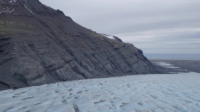 Aerial view of glacier and mountain slope, Iceland.