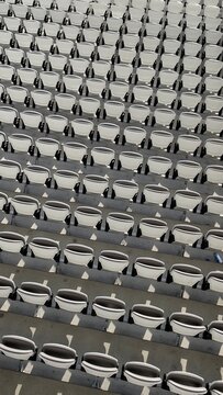 Full frame overhead diagonal view of tiered rows of Empty folded stadium seats