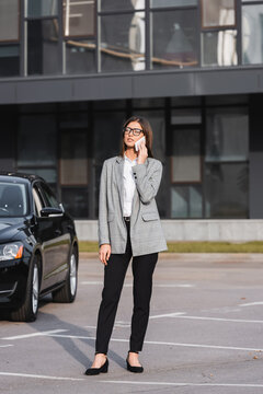Stylish young woman enjoying a fall drive in the city during autumn