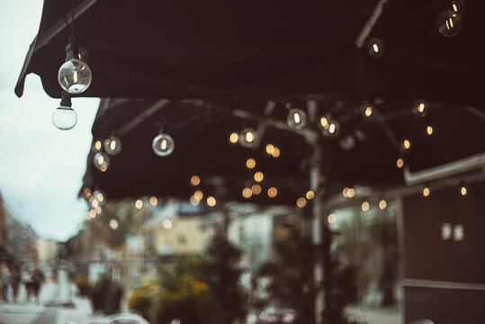 Abstract view of jumbrellas and lights at an Outdoor restaurant terrace, Sweden