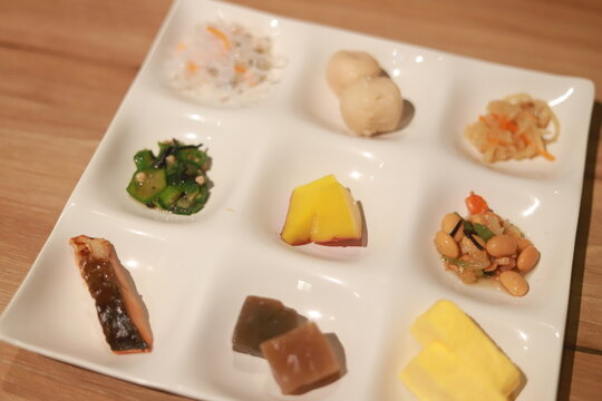 Close-up of a traditional Japanese Obanzai platter including fish, pickles and vegetables on a table