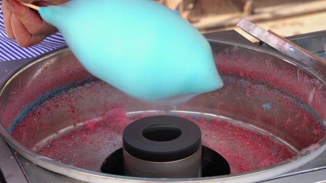Making Blue Cotton Candy on a Stick at a Street Food Stall