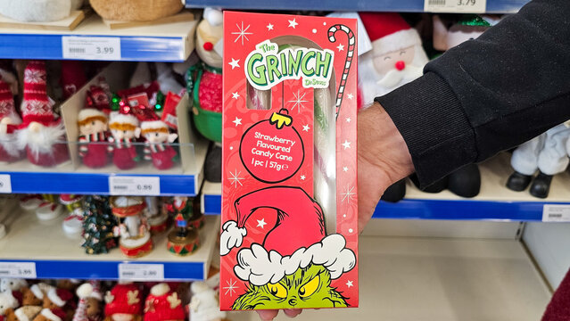 Holding the grinch strawberry candy cane package at christmas shopping
