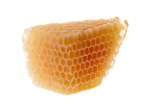 A detailed close up of raw organic beeswax structure filled with sweet nectar showing intricate hexagonal cells harvested from a beehive for nutrition
