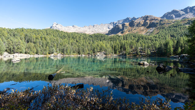 Turquoise waters of Lagh da Saoseo in the Engadin Alps surrounded by autumn nature, creating a peaceful, almost surreal scenery symbolizing mindfulness, clarity, letting go and inner calm.