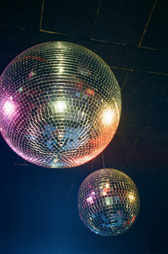 Disco Balls Reflect Light in a Party Venue