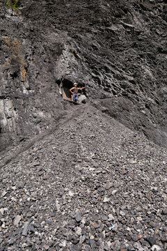 Person standing at entrance of old mine shaft