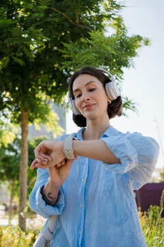 A woman using her smartwatch to select music and check messages