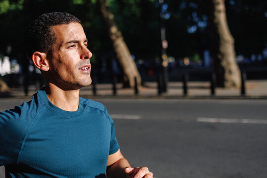 Determined man running outdoors during intense training
