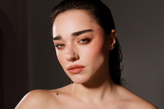 Woman Poses for a Close-Up Picture With a Soft Expression