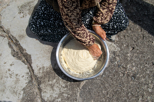 Close-up of Woman Kneading Dough by Hand in Metal Bowl
