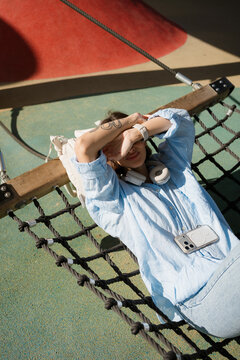 Woman Lying in Hammock Relaxing in Spring Sunshine