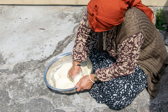 Close-up of Woman Kneading Dough by Hand in Metal Bowl