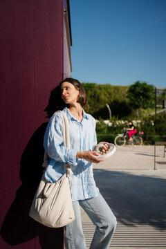 A woman taking a break, holding headphones