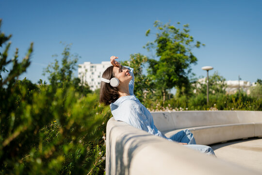 A woman relaxing and meditating in a city park
