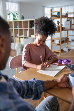 A young girl focused on her studies at home