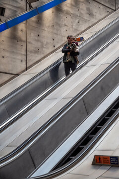 Father Traveling With Baby On Escalator Inside London Underground