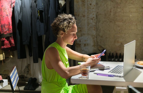 Female artist working on a laptop in her creative studio