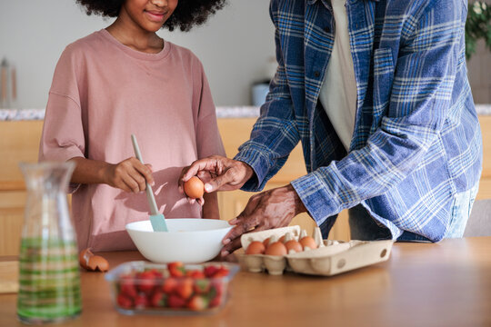 Father and daughter baking together in the kitchen