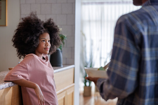 A parent and daughter sharing a moment in the kitchen