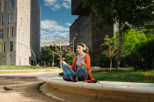 Serene Woman Finding Peace in City Park Outside Office