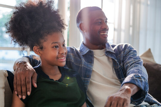 A happy father and daughter sharing a moment together