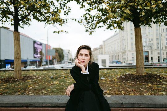 Thoughtful Moment in a Bustling City Center