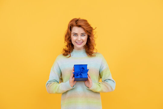 Gifts for woman. Holidays gift celebration and women concept. Portrait of romantic woman celebrating birthday and hold gift presents. Young woman holding gift isolated background. Gift box in hand.