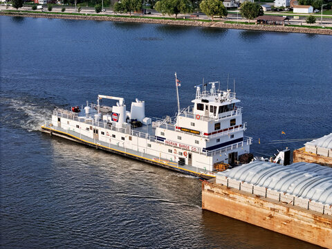 Savanna, Illinois August 16, 2026 The Aaron F. Barrett tugboat navigating South down the Mississippi river pushing a set grain cargo barges