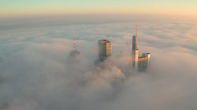 Aerial view of Frankfurt skyline above thick morning fog, Germany.