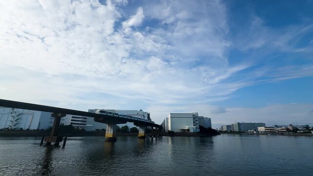 Tokyo Monorail Crossing Keihin Canal Near Showajima Station Under Blue Sky